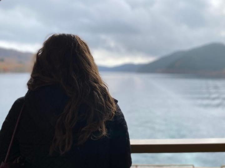 Alicia Boettjer looking out at Lake Ashi in Hakone, Japan from the ferry